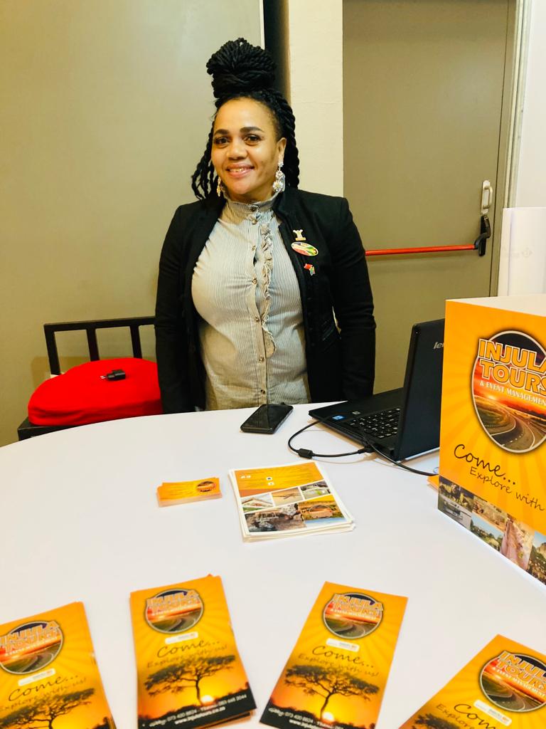 Gibby Memane at the Injula Tours trade stand with brochures