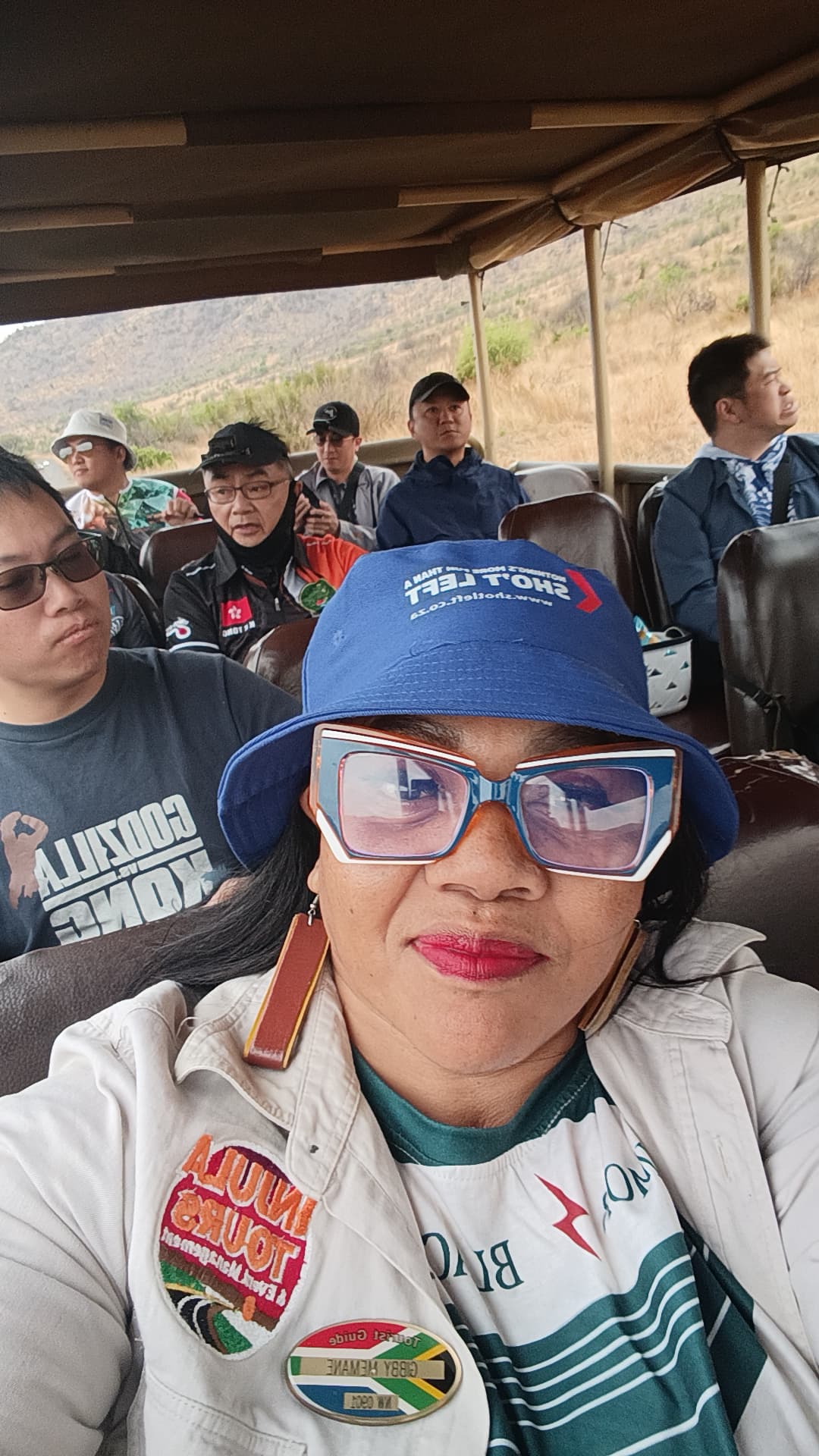 Injula tourist guide with guests on a game drive vehicle