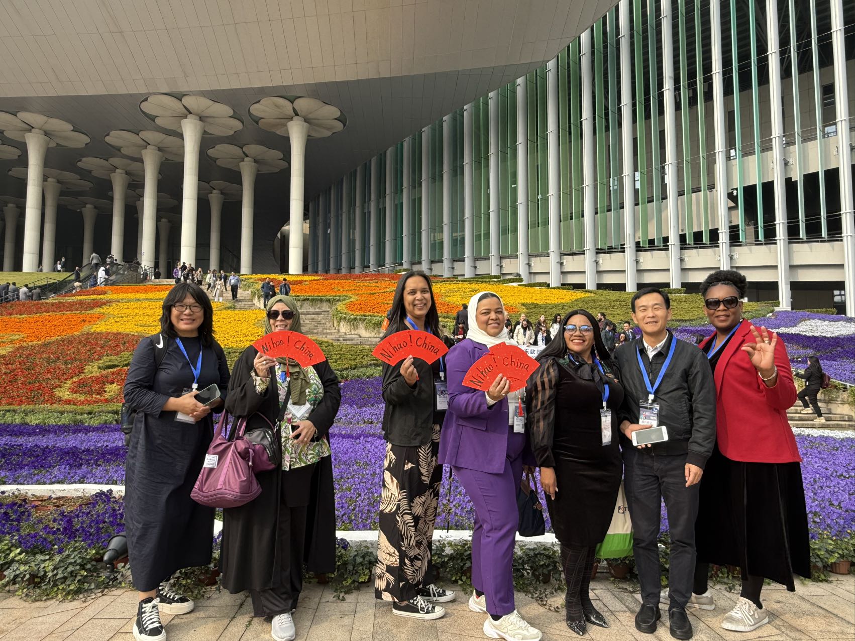 Gibby Memane with an international delegation holding Ni Hao China fans in Shanghai