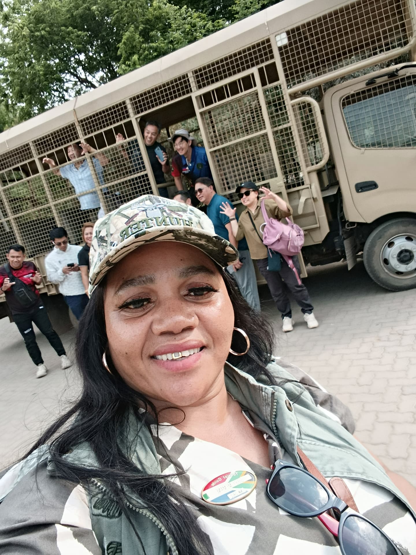 Injula guide with guests boarding an open safari truck